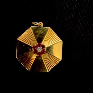 Tiffany  & Company signed 18 K charm. Inserts of diamonds and rubies. Tiffany